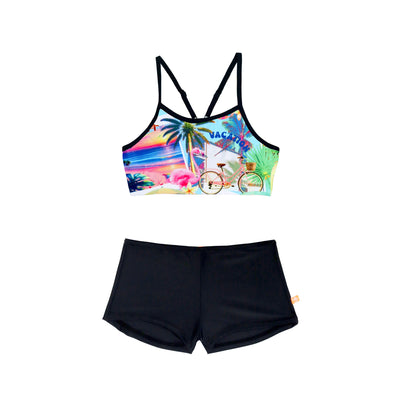 Colorful bikini top with tropical design and black shorts on a white background