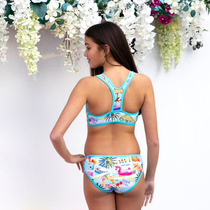 Girl wearing a colorful bikini with a floral background